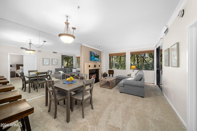 carpeted dining room featuring crown molding