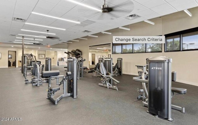 workout area featuring a wealth of natural light, ceiling fan, and a drop ceiling