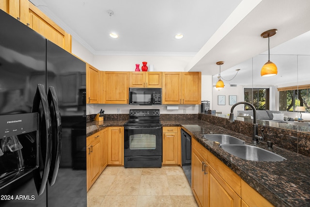 kitchen with hanging light fixtures, dark stone countertops, black appliances, sink, and light tile flooring