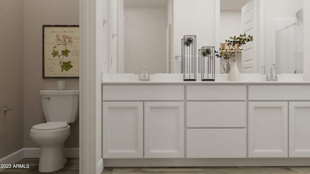 bathroom featuring toilet, wood-type flooring, and vanity