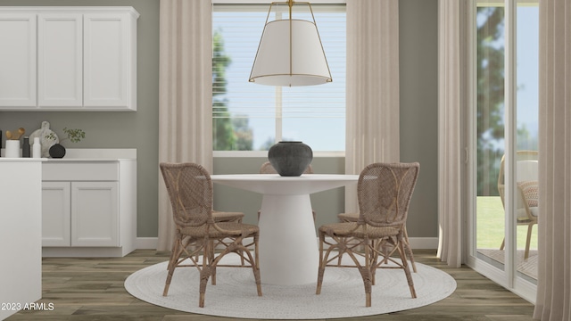 dining area with dark hardwood / wood-style flooring