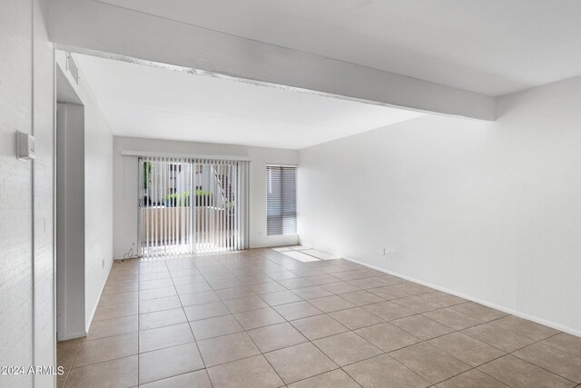 spare room featuring light tile patterned floors