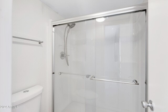 bathroom with toilet and walk in shower