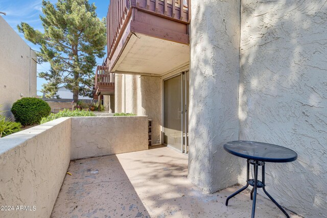 view of exterior entry with a balcony