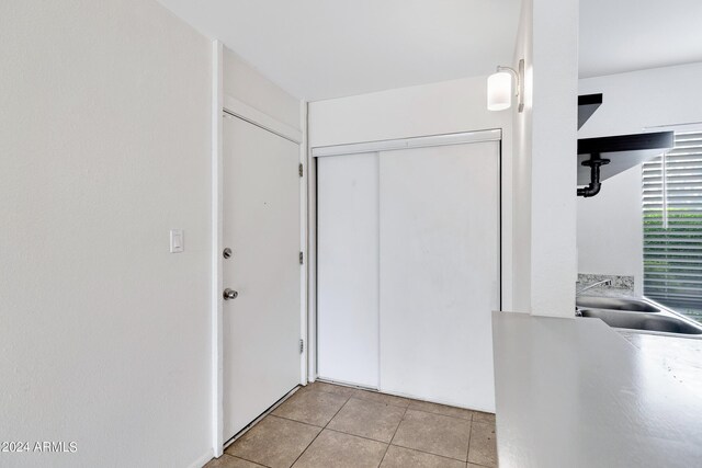 interior space with sink and light tile patterned floors