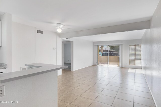 unfurnished room featuring ceiling fan and light tile patterned flooring