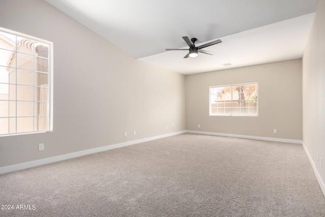 spare room featuring ceiling fan and carpet