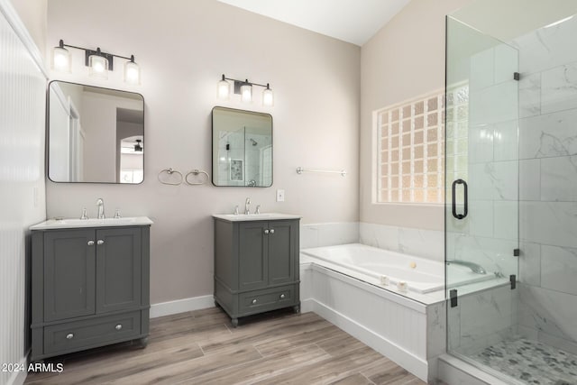 bathroom featuring independent shower and bath, wood-type flooring, and vanity