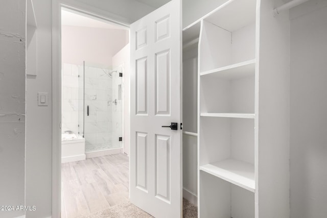 interior space featuring hardwood / wood-style flooring and an enclosed shower