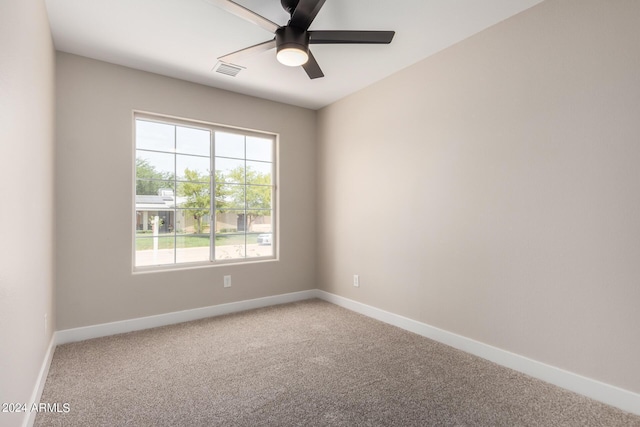 carpeted spare room with ceiling fan