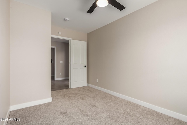 empty room with ceiling fan and carpet floors