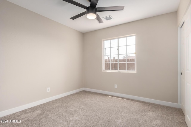 spare room featuring carpet floors and ceiling fan