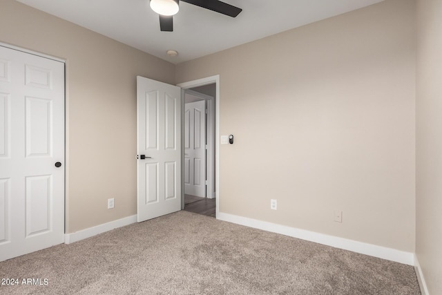 unfurnished bedroom featuring carpet floors and ceiling fan