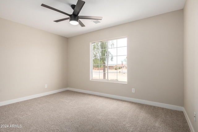 spare room featuring carpet flooring and ceiling fan