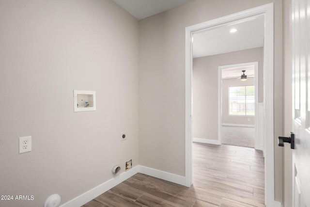 laundry area with gas dryer hookup, hookup for an electric dryer, light hardwood / wood-style floors, and hookup for a washing machine