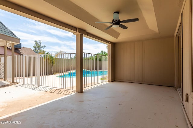 view of patio / terrace with a fenced in pool and ceiling fan