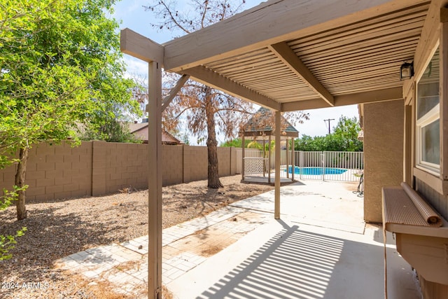 view of patio / terrace featuring a gazebo and a fenced in pool