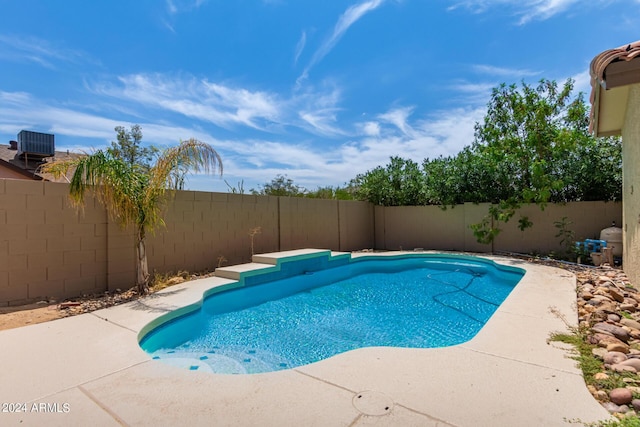 view of swimming pool with central AC and a patio