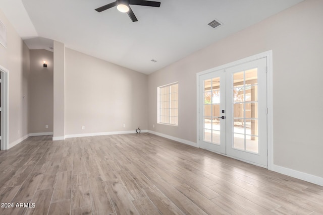 spare room with french doors, lofted ceiling, ceiling fan, and light hardwood / wood-style flooring