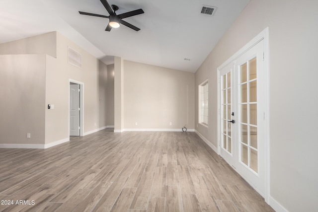 unfurnished living room featuring lofted ceiling, light hardwood / wood-style flooring, french doors, and ceiling fan