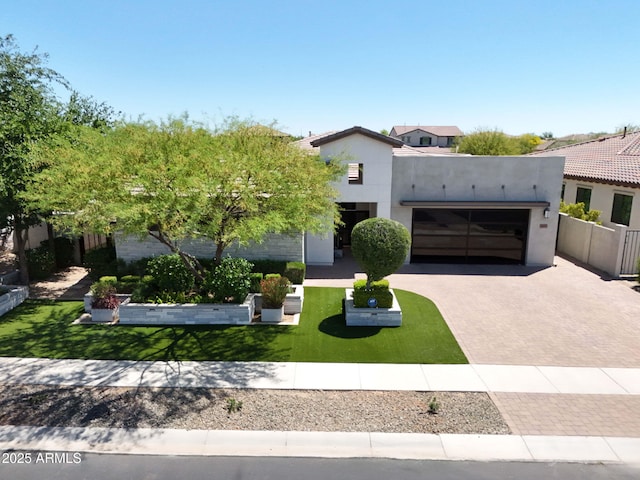4571 S Pinaleno Dr W, Chandler, AZ 85249 - view of front of house featuring a front yard, a garage, decorative driveway, stucco siding, and fence