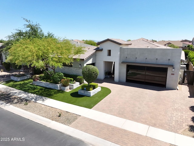4571 S Pinaleno Dr W, Chandler, AZ 85249 - view of front of house with stucco siding, decorative driveway, a tiled roof, and a garage