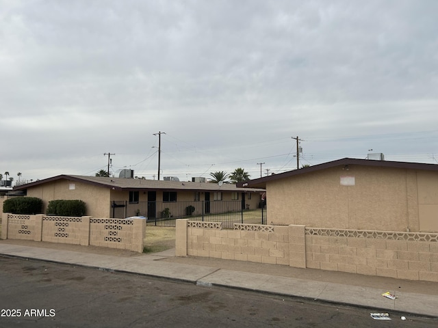 view of front facade featuring a fenced front yard and stucco siding