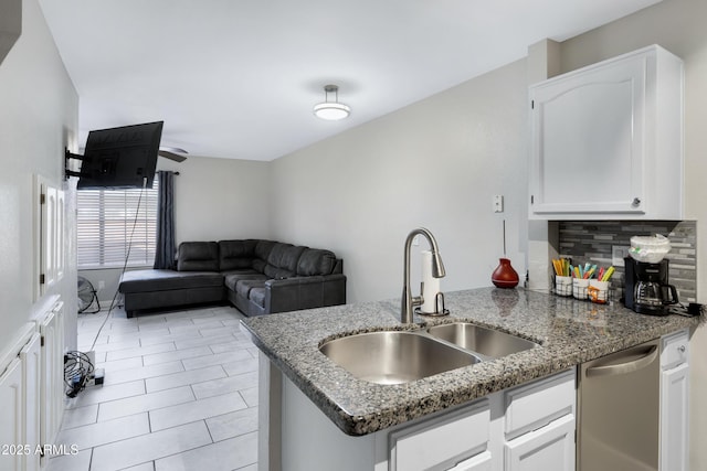 kitchen with dishwasher, sink, and white cabinets