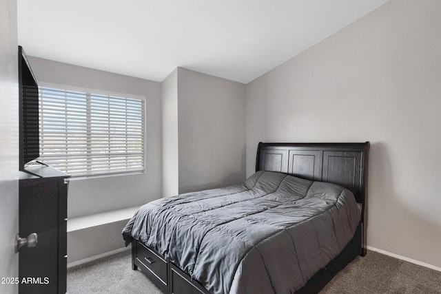 bedroom with lofted ceiling and light carpet