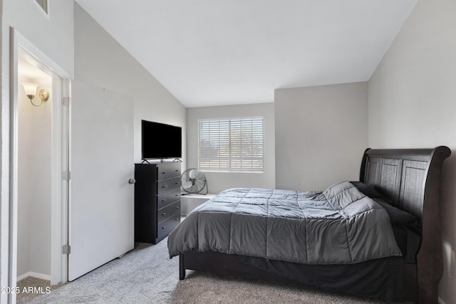 bedroom with light carpet and vaulted ceiling