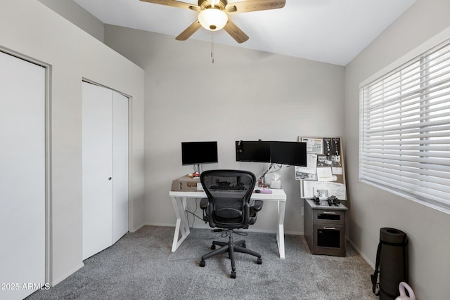 carpeted home office featuring ceiling fan