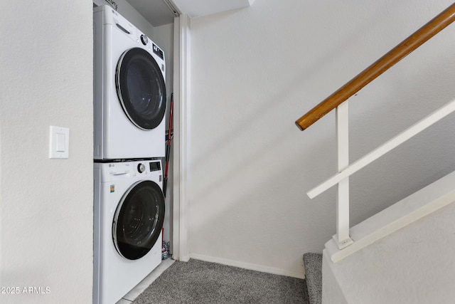 clothes washing area featuring carpet flooring and stacked washing maching and dryer