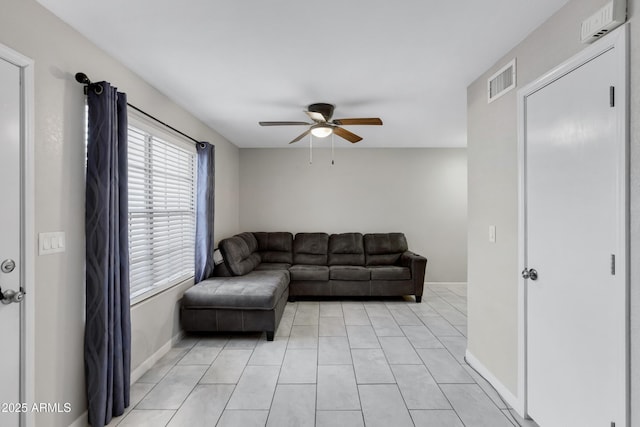 tiled living room featuring ceiling fan