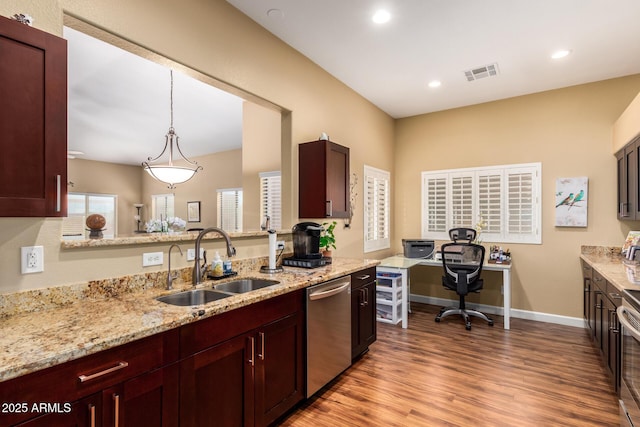 18650 N 91st Ave Unit 3301, Peoria, AZ 85382 - kitchen featuring a sink, dishwasher, wood finished floors, light stone counters, and hanging light fixtures