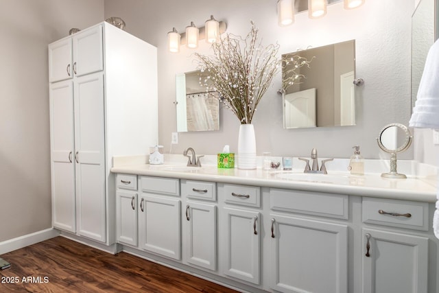 18650 N 91st Ave Unit 3301, Peoria, AZ 85382 - bathroom with wood finished floors, double vanity, and baseboards