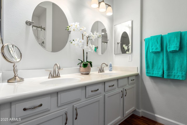18650 N 91st Ave Unit 3301, Peoria, AZ 85382 - bathroom with wood finished floors, double vanity, and baseboards