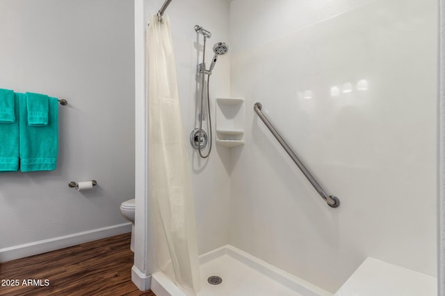 18650 N 91st Ave Unit 3301, Peoria, AZ 85382 - full bath featuring a stall shower, toilet, wood finished floors, and baseboards