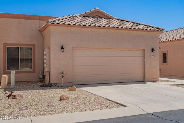 18650 N 91st Ave Unit 3301, Peoria, AZ 85382 - view of front of property featuring driveway, a garage, stucco siding, and a tile roof