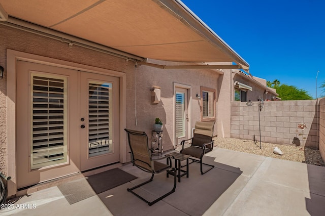 18650 N 91st Ave Unit 3301, Peoria, AZ 85382 - view of patio / terrace featuring fence and french doors