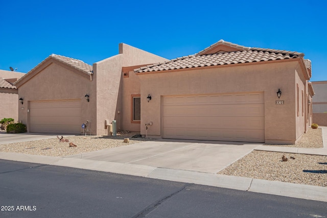 18650 N 91st Ave Unit 3301, Peoria, AZ 85382 - view of front facade featuring an attached garage, stucco siding, concrete driveway, and a tiled roof