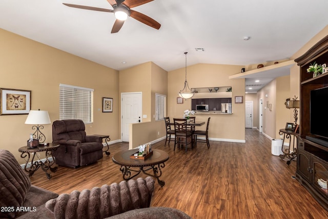 18650 N 91st Ave Unit 3301, Peoria, AZ 85382 - living area with a ceiling fan, dark wood finished floors, vaulted ceiling, and baseboards