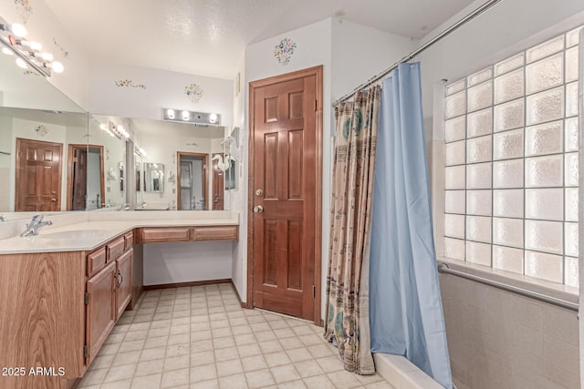 bathroom with curtained shower and double vanity