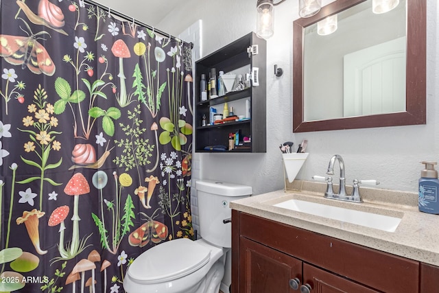 full bath with a shower with curtain, toilet, vanity, and a textured wall