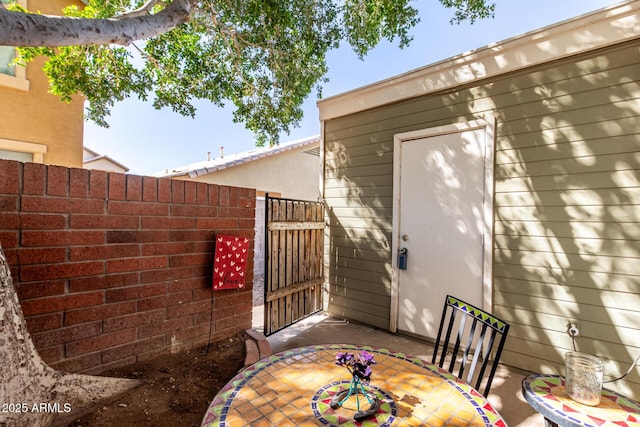 view of patio with a gate and fence