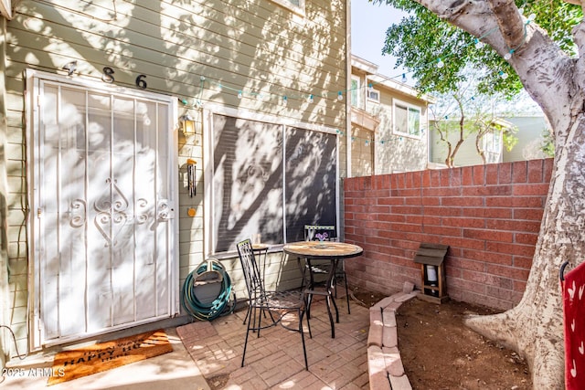 view of patio featuring fence