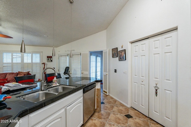 kitchen with a sink, a textured ceiling, white cabinetry, dishwasher, and vaulted ceiling