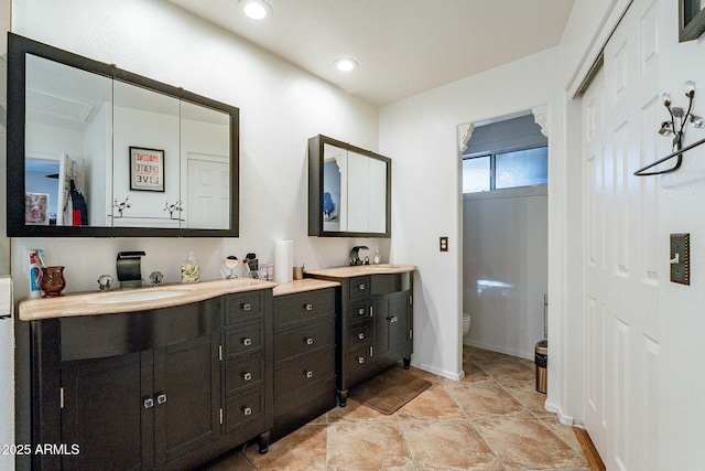 bathroom with vanity, toilet, and recessed lighting