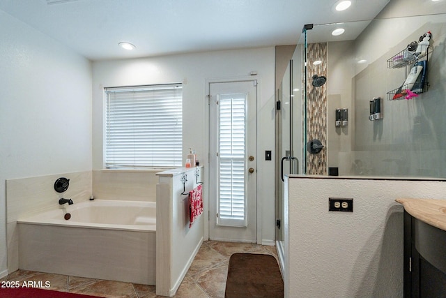 bathroom featuring vanity, a bath, a healthy amount of sunlight, and a stall shower