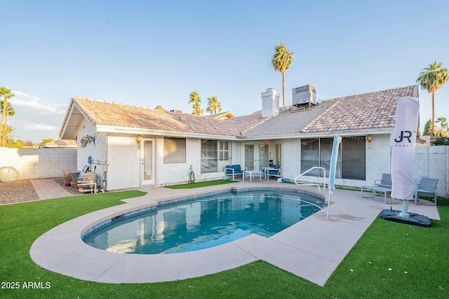 rear view of house with a patio, central air condition unit, fence, and stucco siding