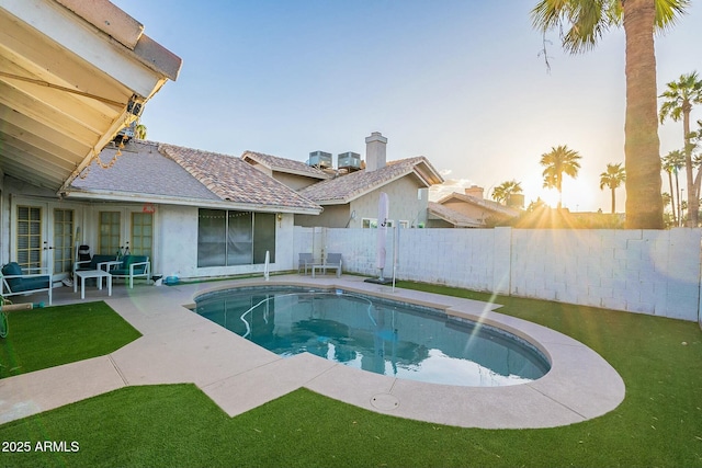 view of pool featuring a patio area, a fenced in pool, french doors, and a fenced backyard